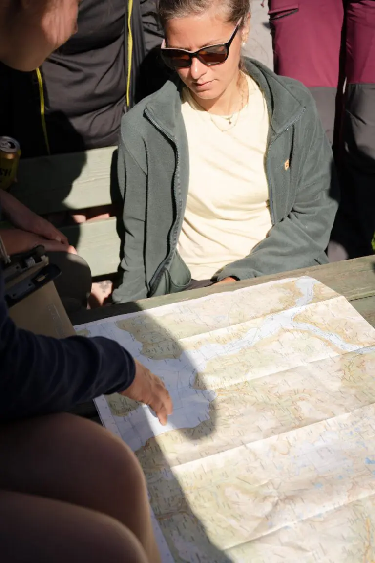 people looking at a map during a kayak trip briefing