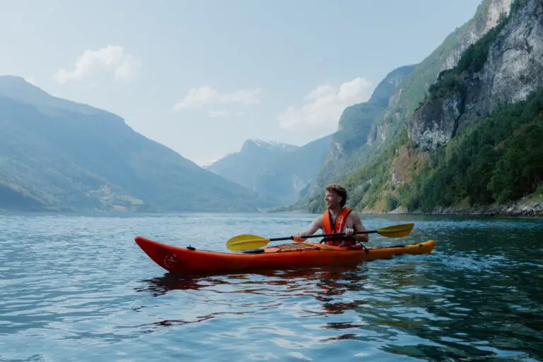 man kayaking on a fjord in Norway