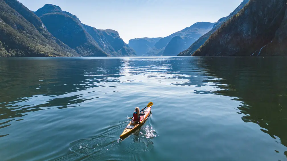 Woman kayaking in the fjords in Norway