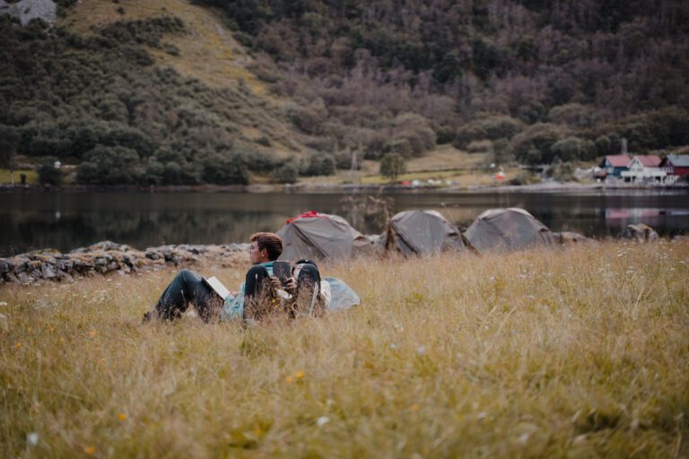 2 men chilling in gras field with tents - Kajakken - Noorwegen fjord - wandelen in Noorwegen - kayaking - vanaf luchthaven Brussel