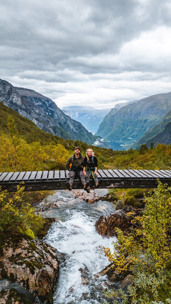 People sitting on a bridge on a hike in Norway - Kayaking - Norway fjord - hiking in Norway - kayaking - from Brussels airport